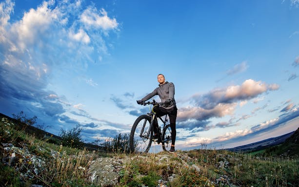 Biker on a trail during the Guided Biking & Kayaking Tour at Furnas.