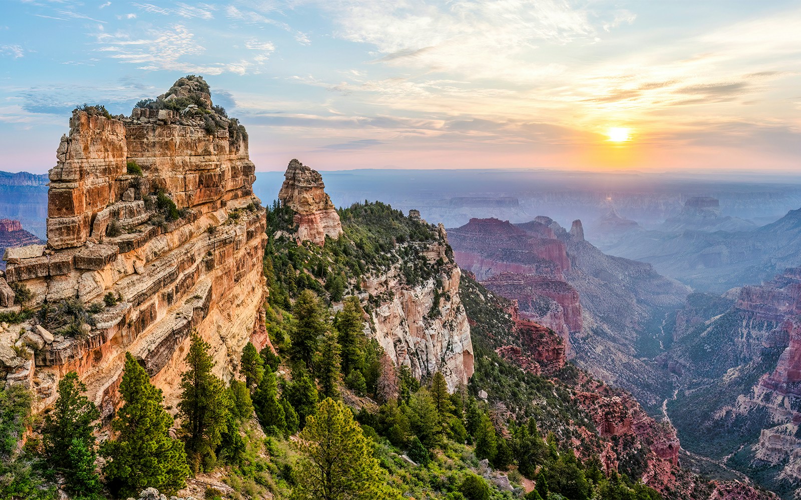 Roosevelt Point Overlook sunrise view with vibrant sky and canyon landscape, Grand Canyon National Park.