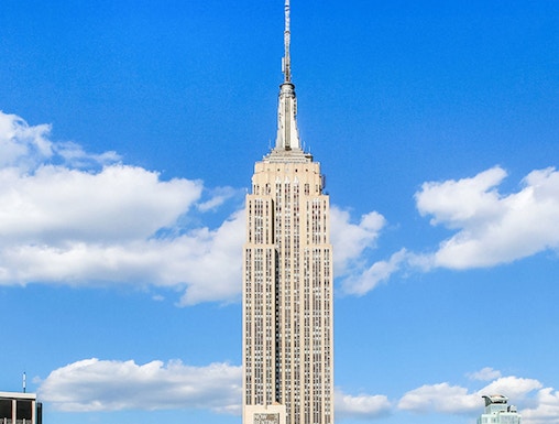 Empire State Building under a clear blue sky in Manhattan, NYC.