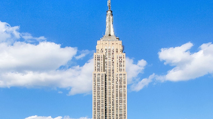 Empire State Building under a clear blue sky in Manhattan, NYC.