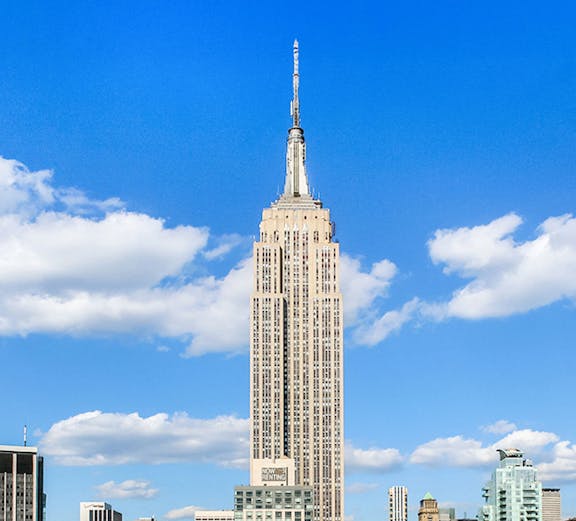 Empire State Building under a clear blue sky in Manhattan, NYC.