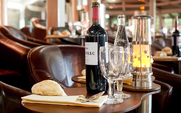 Dinner table setup with wine and bread on a Seine River cruise in Paris.