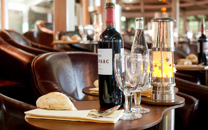 Dinner table setup with wine and bread on a Seine River cruise in Paris.