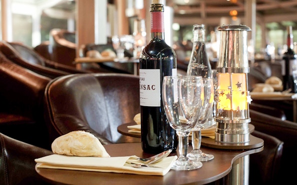 Dinner table setup with wine and bread on a Seine River cruise in Paris.