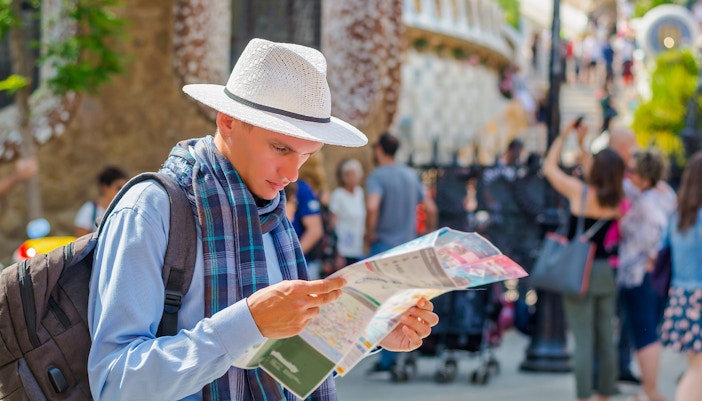 Man reading map outside Park Guell, Barcelona.
