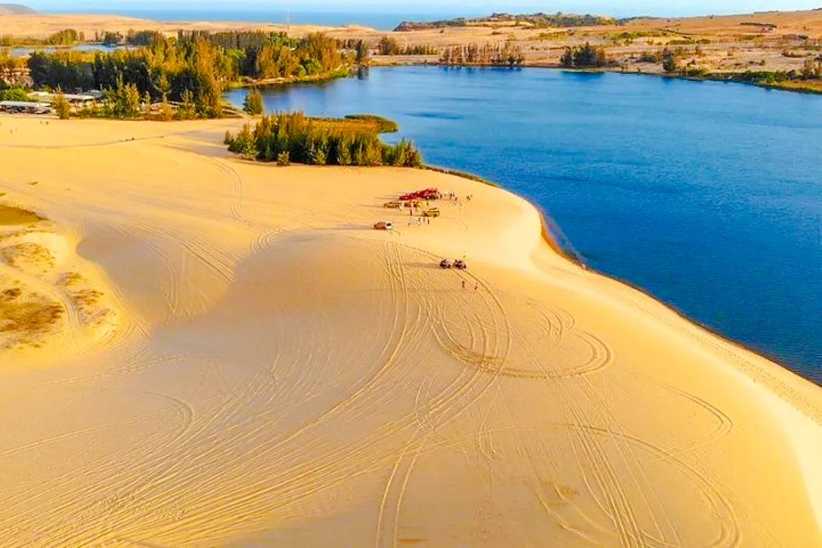 Mui Ne sand dunes with jeeps and lake, full-day tour from Ho Chi Minh City.