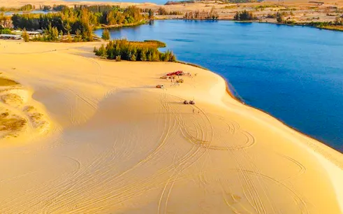 Mui Ne sand dunes with jeeps and lake, full-day tour from Ho Chi Minh City.