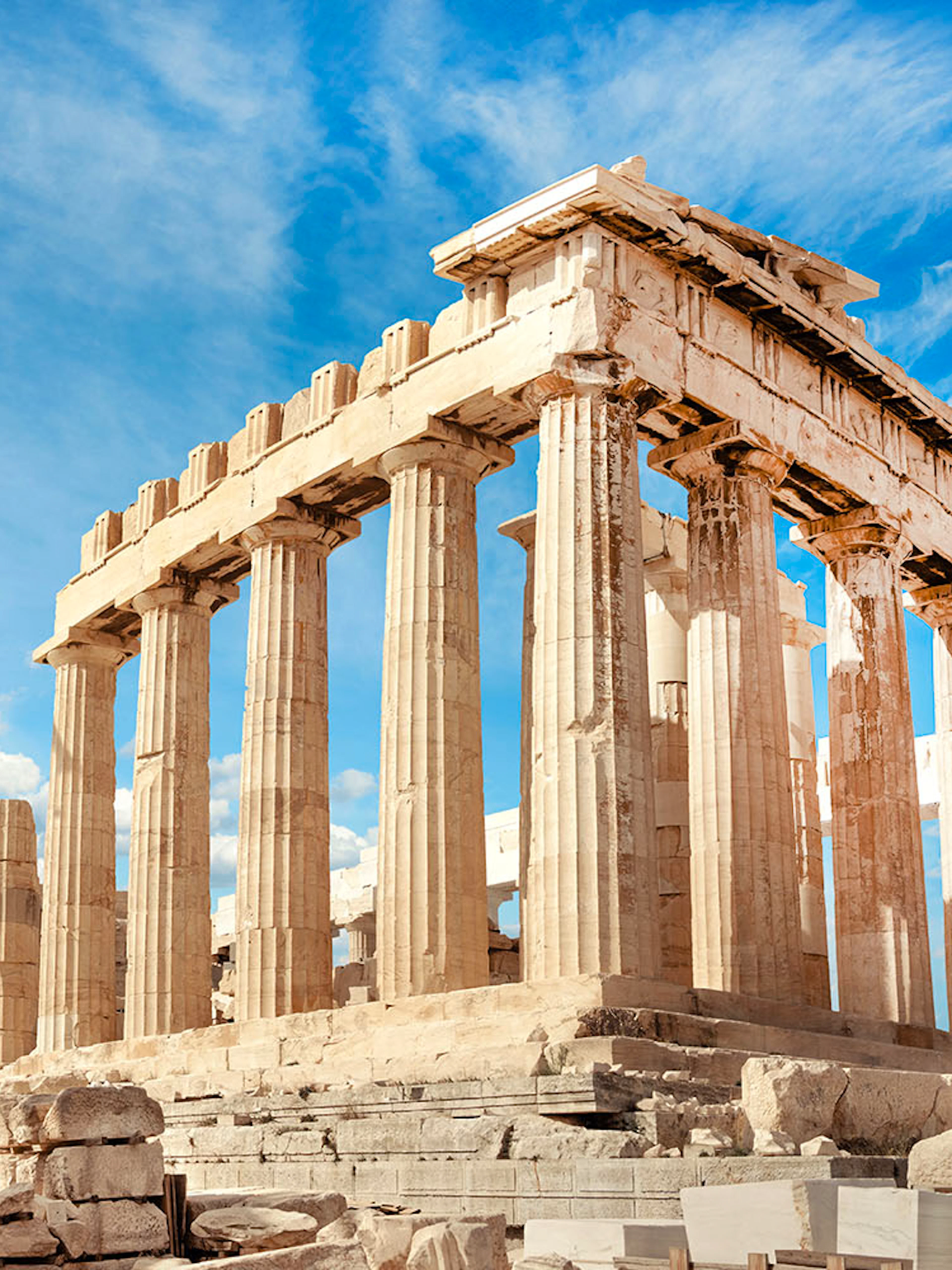Parthenon temple on the Acropolis in Athens under a blue sky.