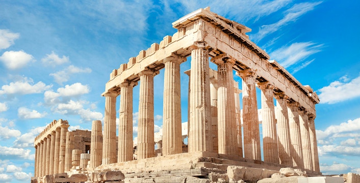 Parthenon temple on the Acropolis in Athens under a blue sky.