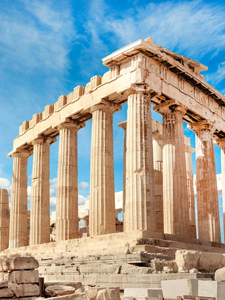 Parthenon temple on the Acropolis in Athens under a blue sky.