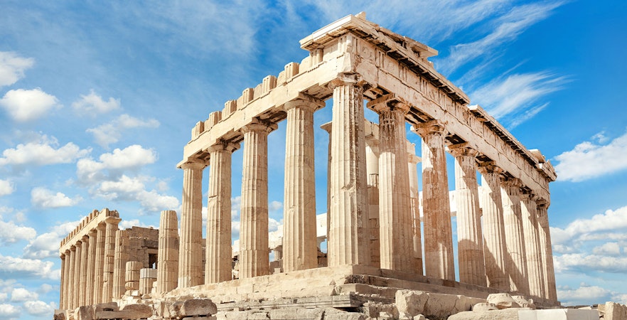 Parthenon temple on the Acropolis in Athens under a blue sky.