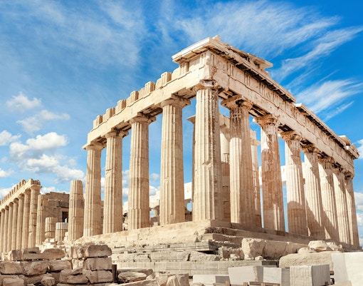 Parthenon temple on the Acropolis in Athens under a blue sky.
