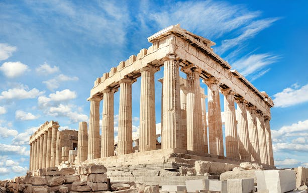 Parthenon temple on the Acropolis in Athens under a blue sky.