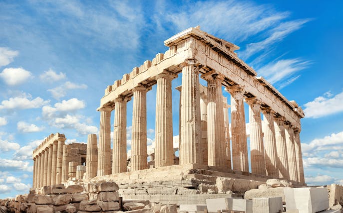 Parthenon temple on the Acropolis in Athens under a blue sky.
