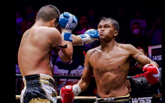 Fighter delivering a punch at SRC SIAM REAL COMBAT, World Siam Stadium, Bangkok.