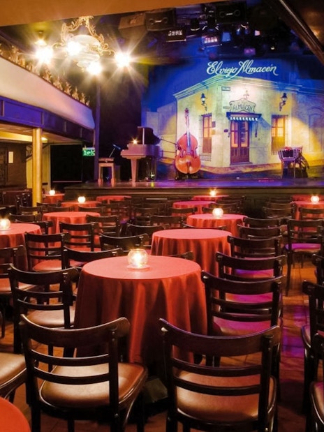 El Viejo Almacén Tango seating area with stage and red tablecloths.