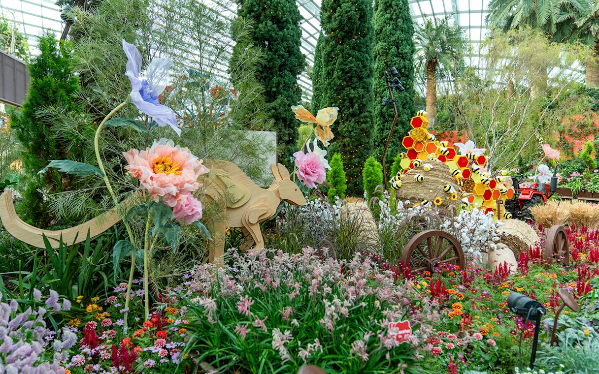 Gardens by the Bay floral display with wooden kangaroo and colorful flowers.
