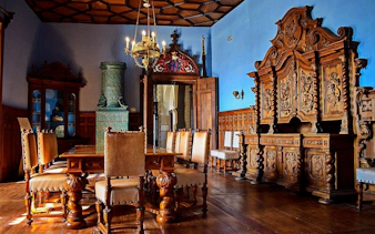 Dining room with ornate wooden furniture in Trakošćan Castle, Croatia.