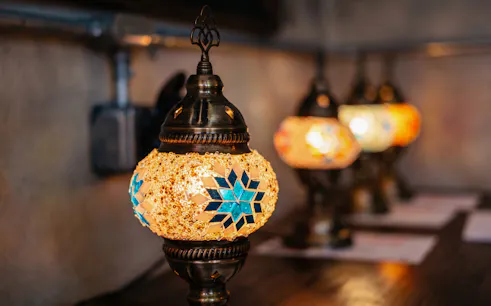 Turkish mosaic lamp with blue star pattern in Istanbul workshop.