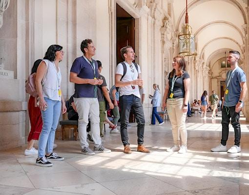 Experienced guide leading a group on a guided tour inside the Prado Museum, showcasing famous artworks