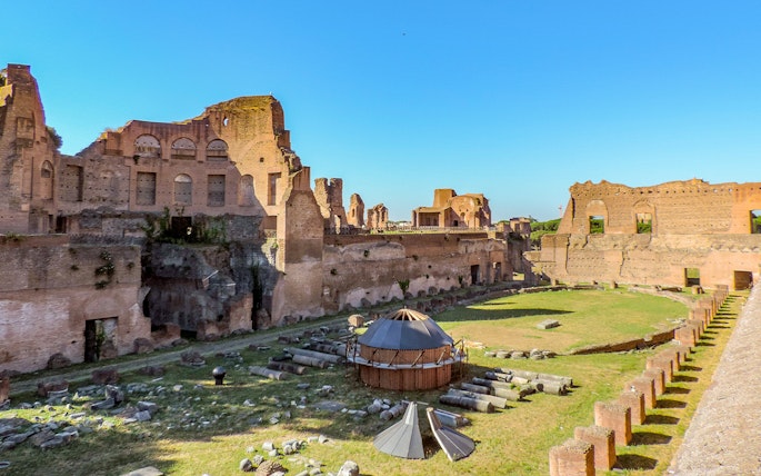 Colosseum Underground tour with views of Palatine Hill ruins on a sunny day in Rome, Italy.