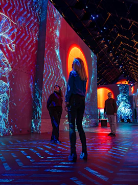 Visitors exploring immersive digital art projections at Fabrique des Lumières.