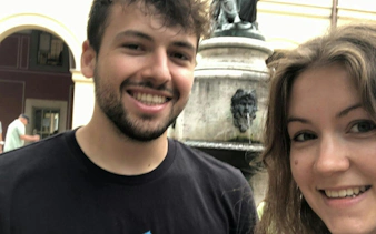 Visitors at a historic fountain in Munich during a self-guided city exploration game.