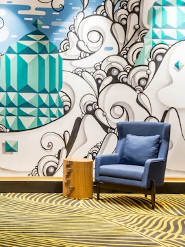Colorful mural and seating area at Plaza Premium Lounge, Rio de Janeiro Airport, T2.