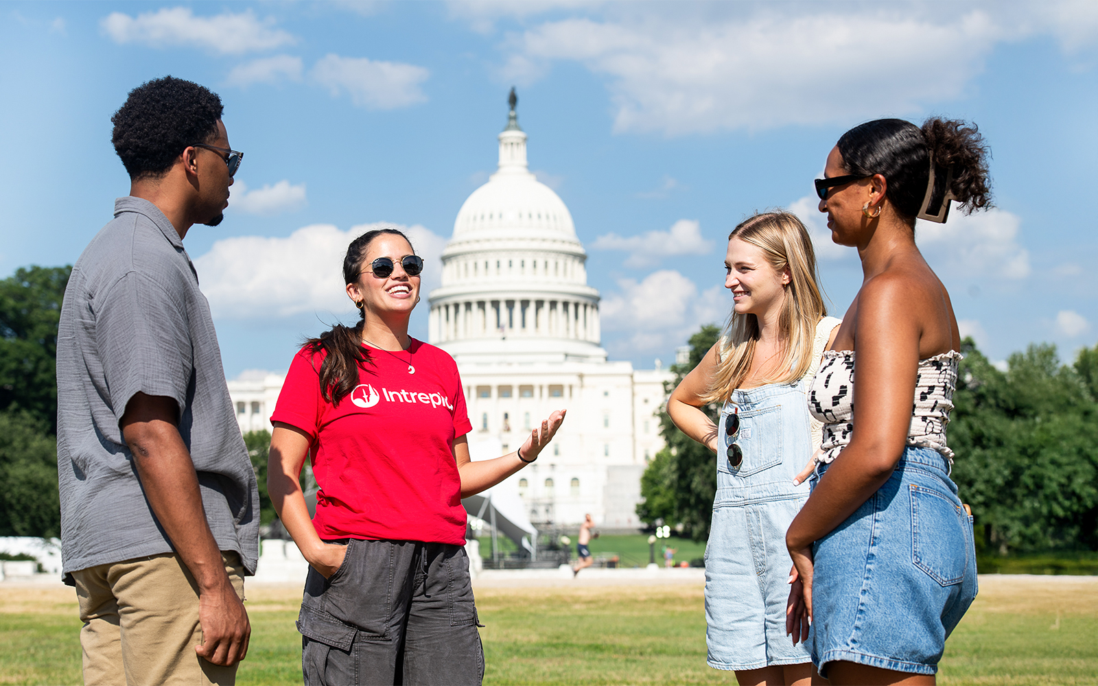 Tour group discussing in front of the U.S. Capitol on Washington DC Monuments and Memorials Electric Cart Tour.