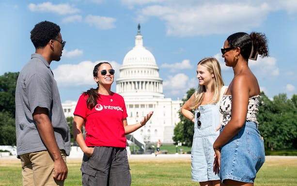 Tour group discussing in front of the U.S. Capitol on Washington DC Monuments and Memorials Electric Cart Tour.