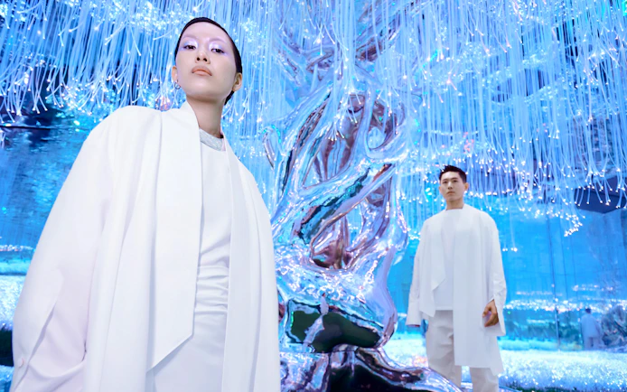 People at Flora Zone in AYA Universe, Dubai, standing near illuminated art installation.