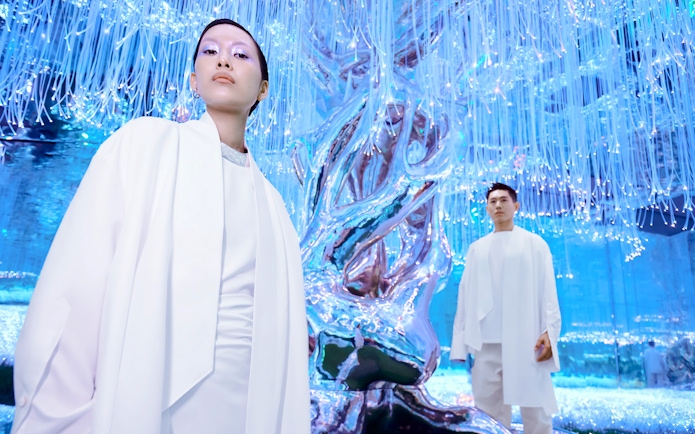 People at Flora Zone in AYA Universe, Dubai, standing near illuminated art installation.