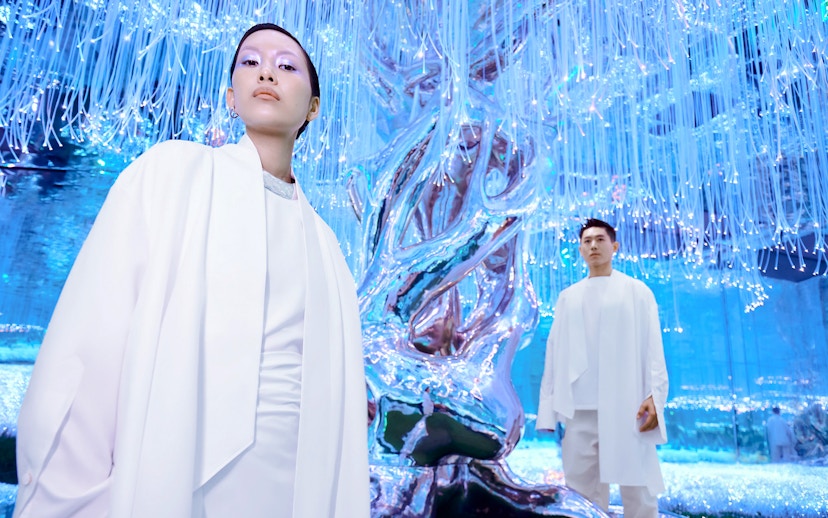 People at Flora Zone in AYA Universe, Dubai, standing near illuminated art installation.