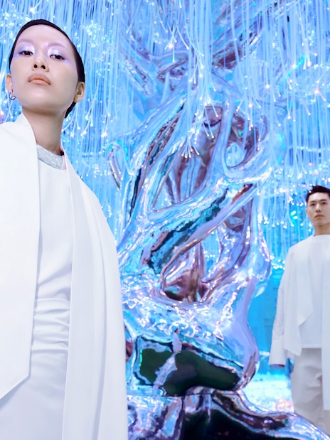 People at Flora Zone in AYA Universe, Dubai, standing near illuminated art installation.