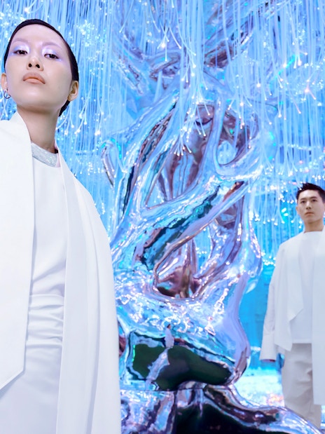 People at Flora Zone in AYA Universe, Dubai, standing near illuminated art installation.