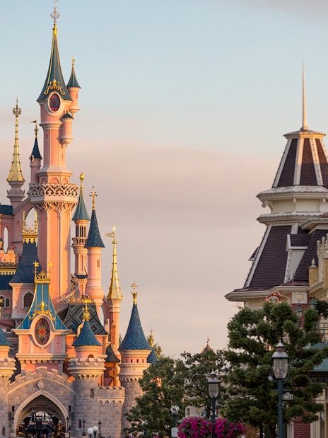 Sleeping Beauty Castle at Disneyland Paris with surrounding buildings.