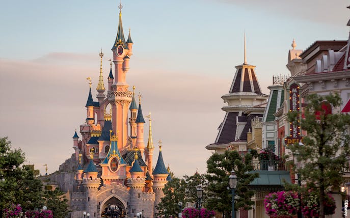 Sleeping Beauty Castle at Disneyland Paris with surrounding buildings.