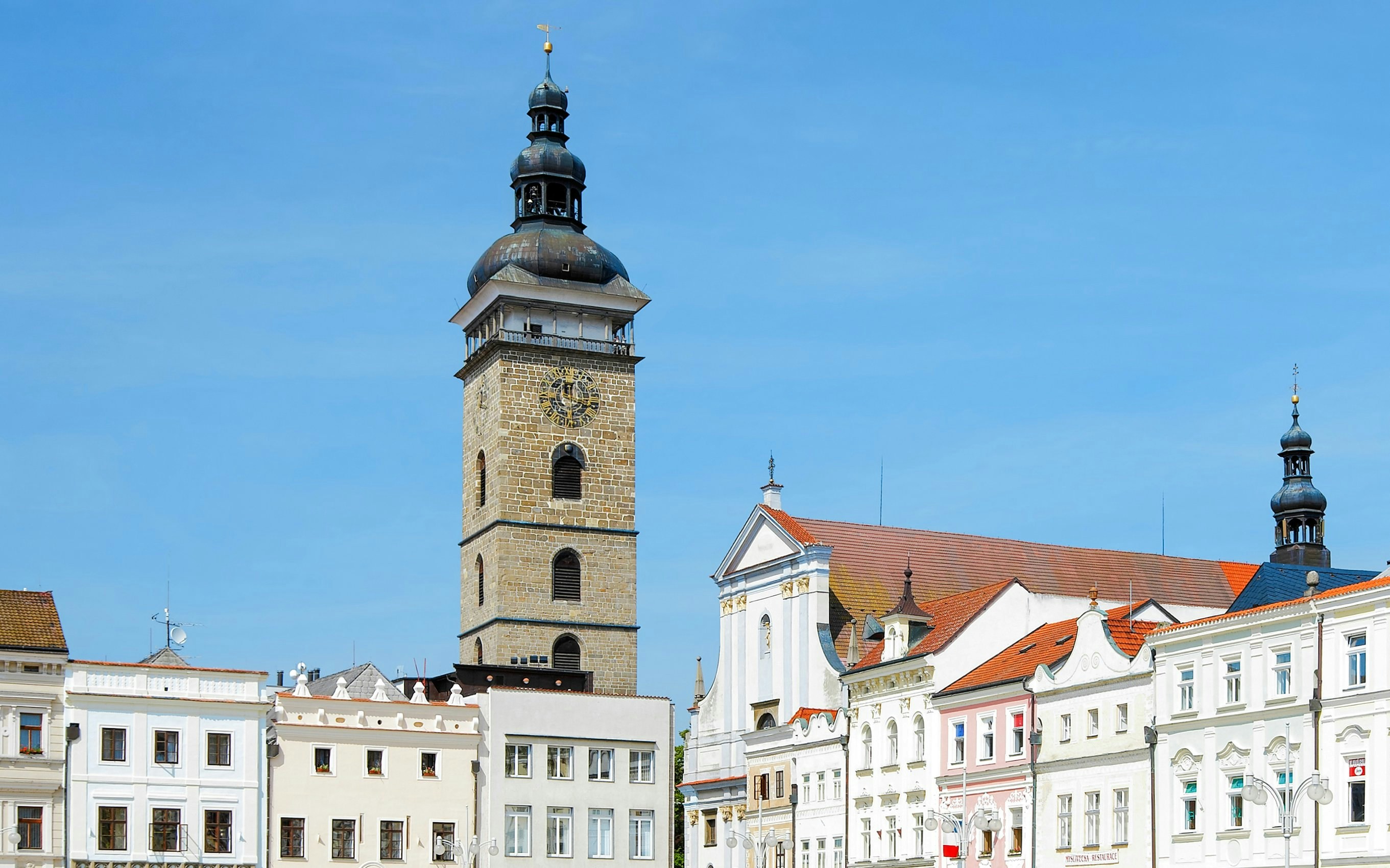 Black Tower in Cesky Krumlov with surrounding historic buildings.