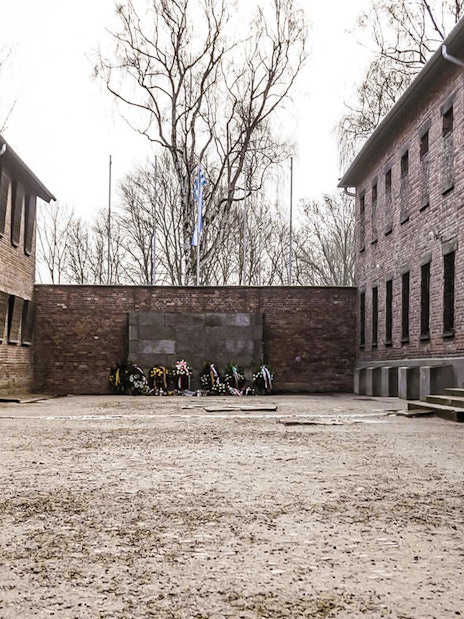 Courtyard with memorial wreaths at Auschwitz concentration camp, Poland.