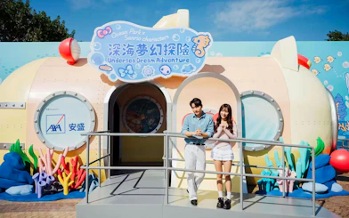 Couple standing in front of Undersea Dream Adventure entrance at Ocean Park.