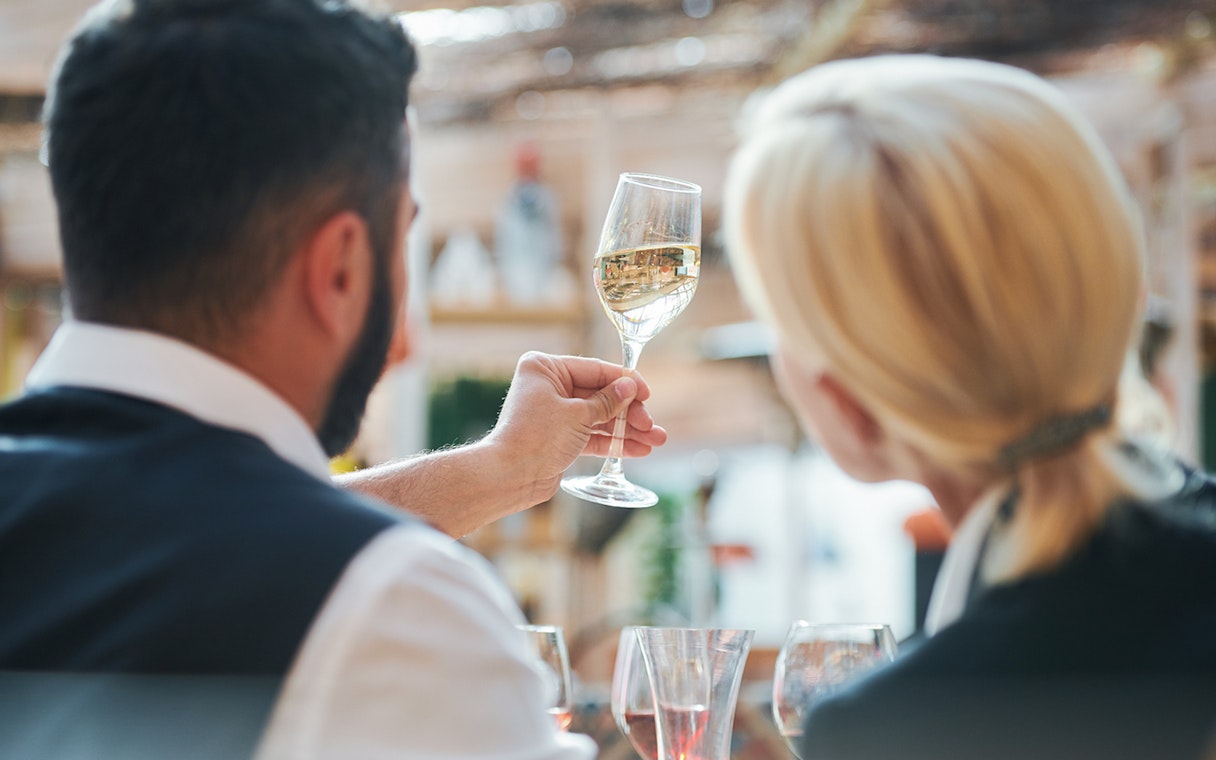 Young couple tasting wine during a Pisa tour.