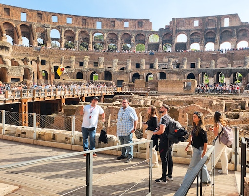Visitors exploring the interior of the Colosseum on a private guided tour in Rome.