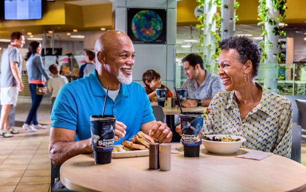 Couple enjoying a meal at Kennedy Space Center café.