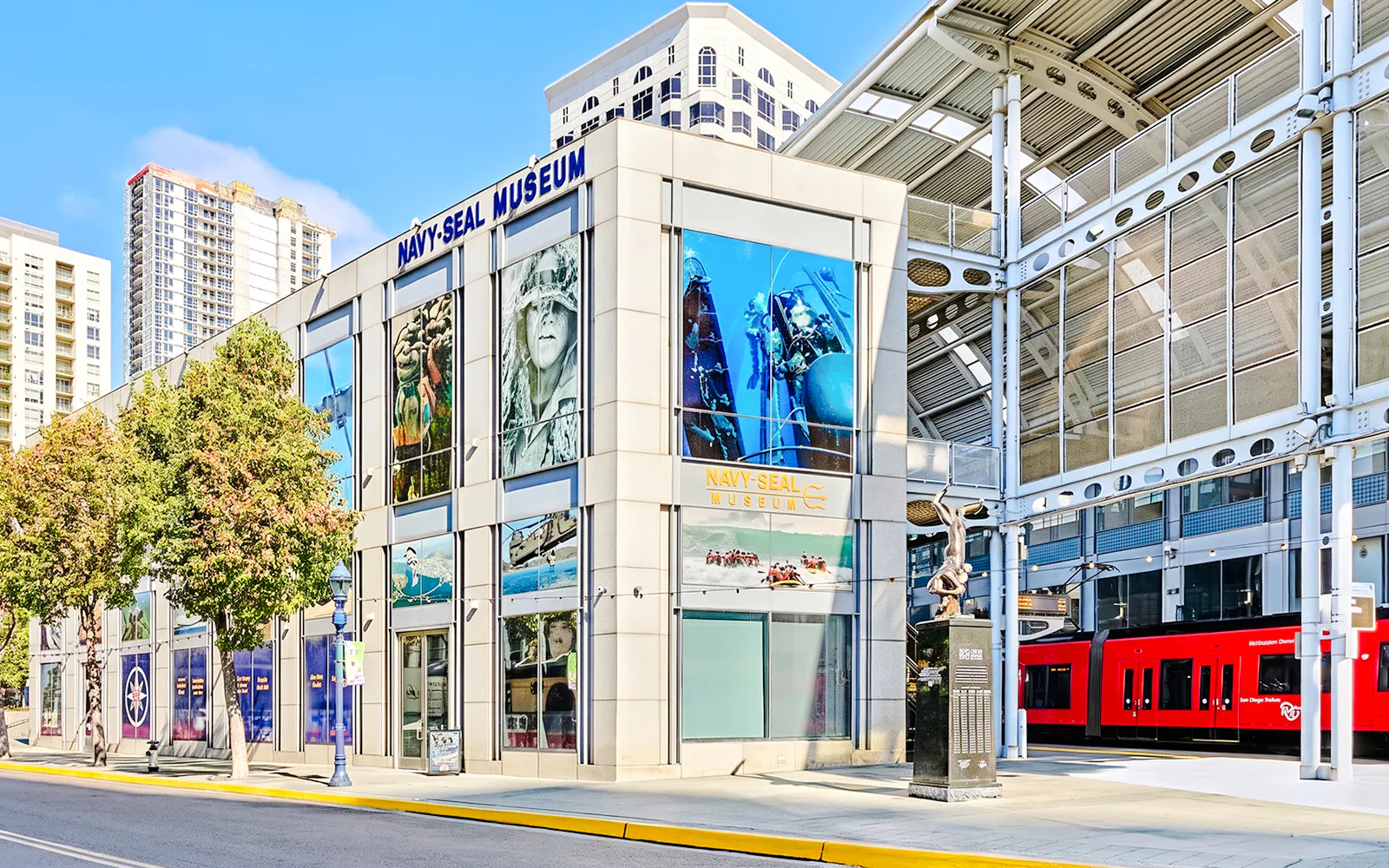 National Navy SEAL Museum exterior in San Diego with nearby red trolley.