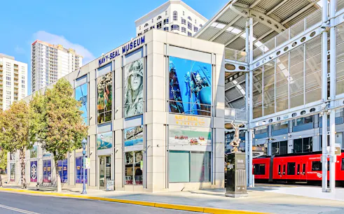 National Navy SEAL Museum exterior in San Diego with nearby red trolley.