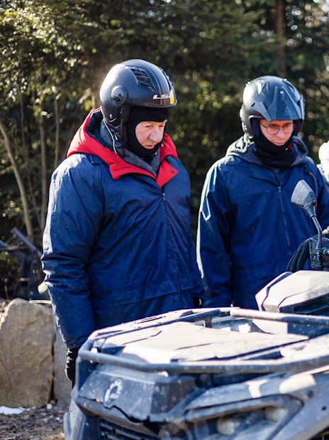 Group preparing for quad biking in Zakopane with guide explaining controls.