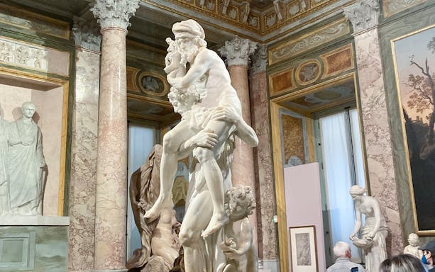 Gian Lorenzo Bernini's sculpture of Aeneas, Anchises, and Ascanius in a museum setting.