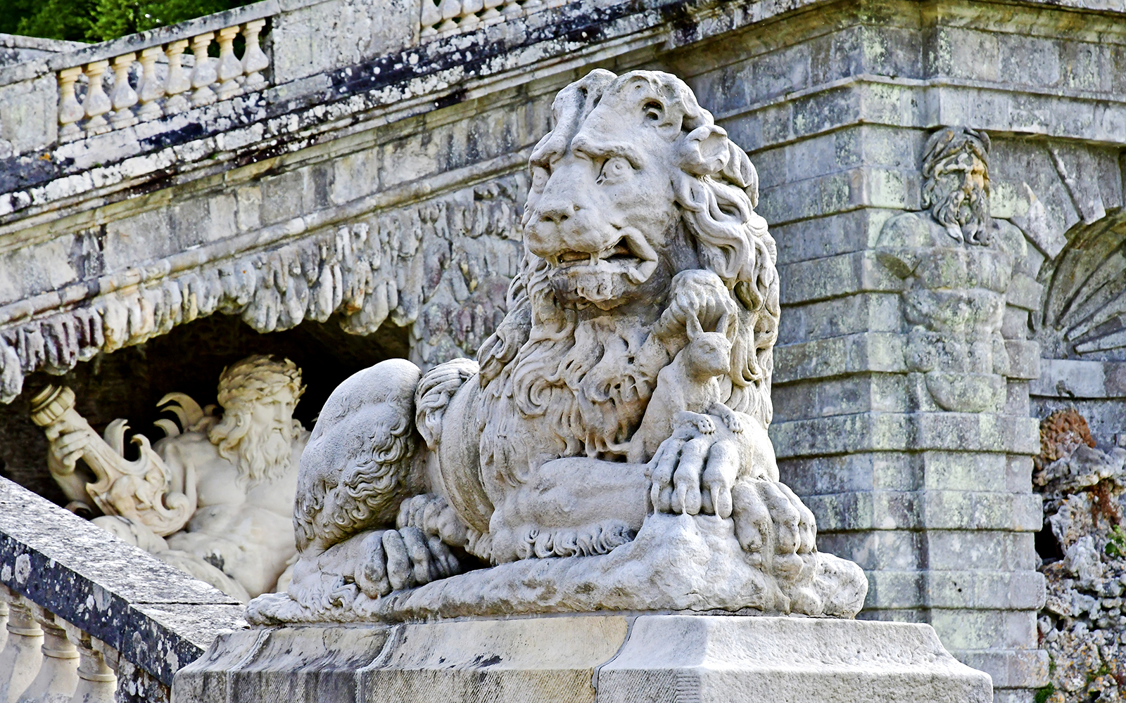Stone lion sculpture at Vaux-le-Vicomte Castle entrance, France.