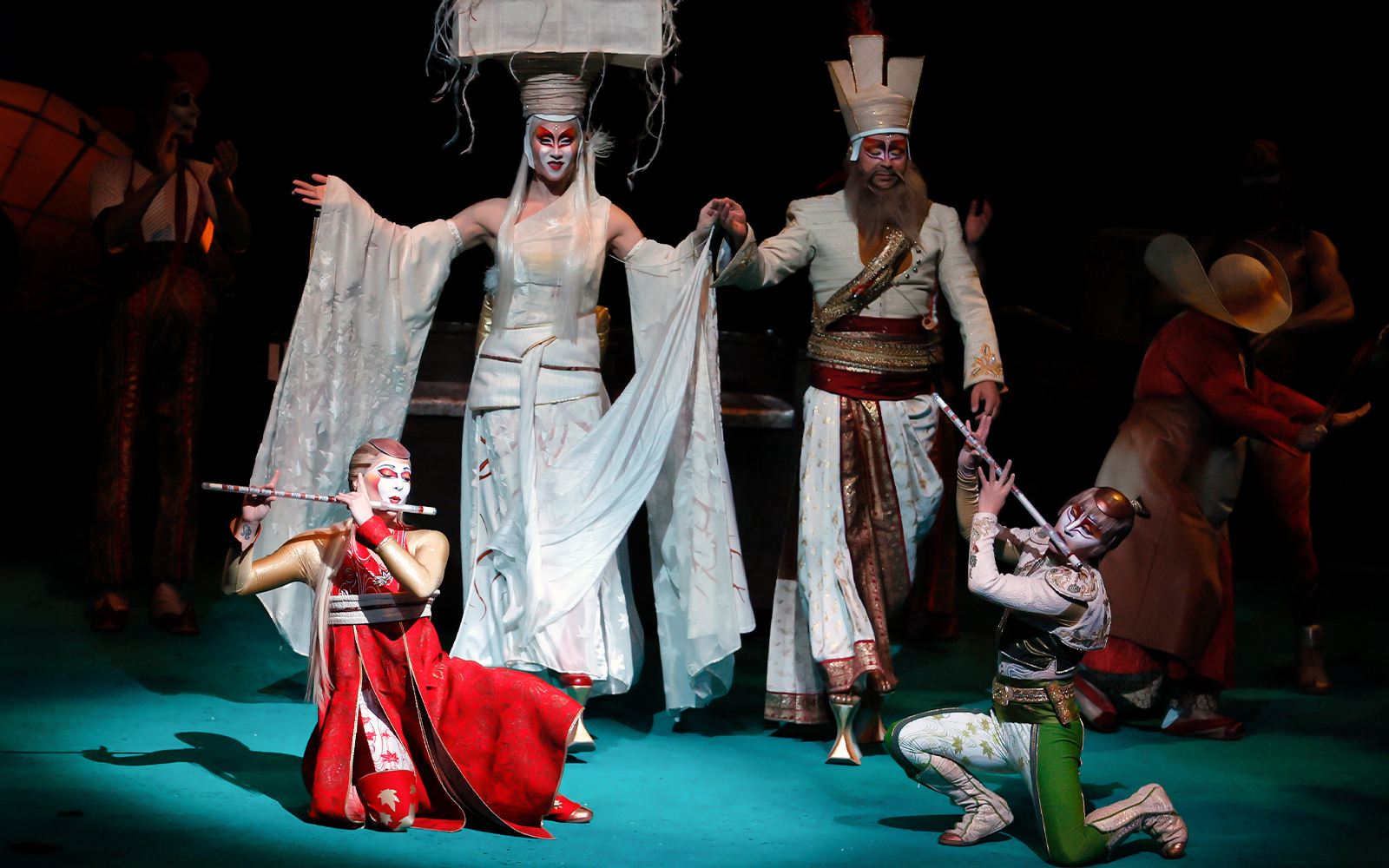 Performers in elaborate costumes on stage during Cirque du Soleil KÀ show.