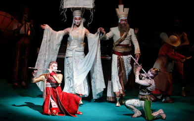 Performers in elaborate costumes on stage during Cirque du Soleil KÀ show.